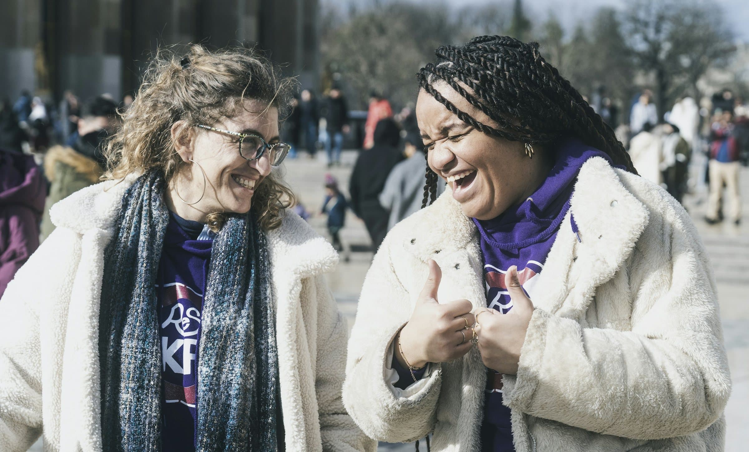 Two friends laughing together outside
