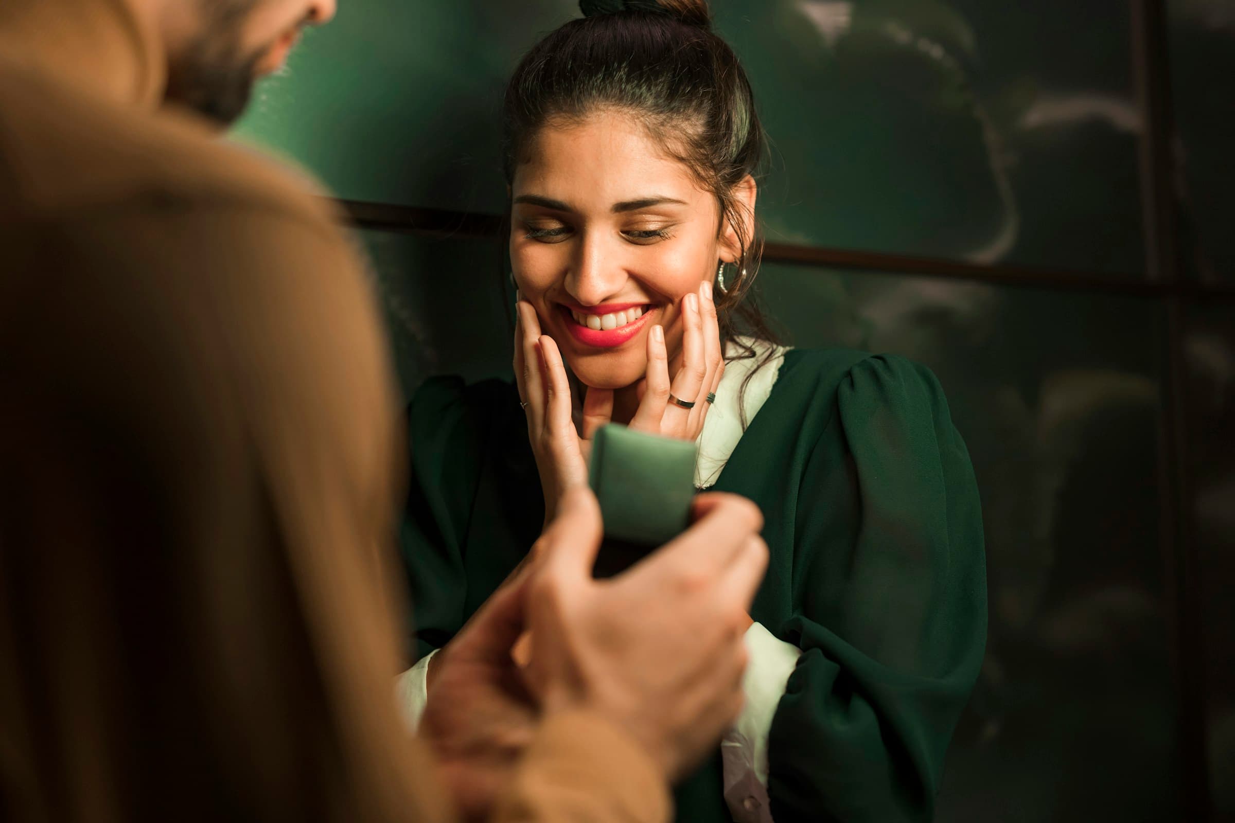 Someone smiling as a friend shows them a message